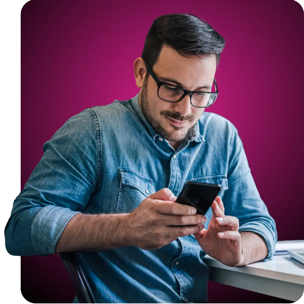 Man in glasses looking at his phone